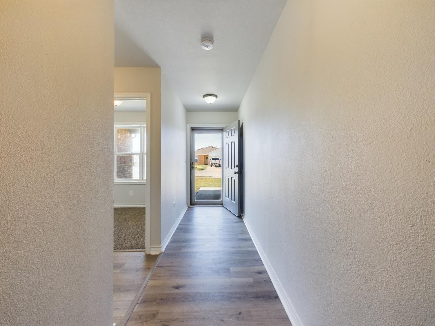 6306 25th Street Lubbock, TX 79407 - Photo 4 of 37 a view of a hallway with wooden floor