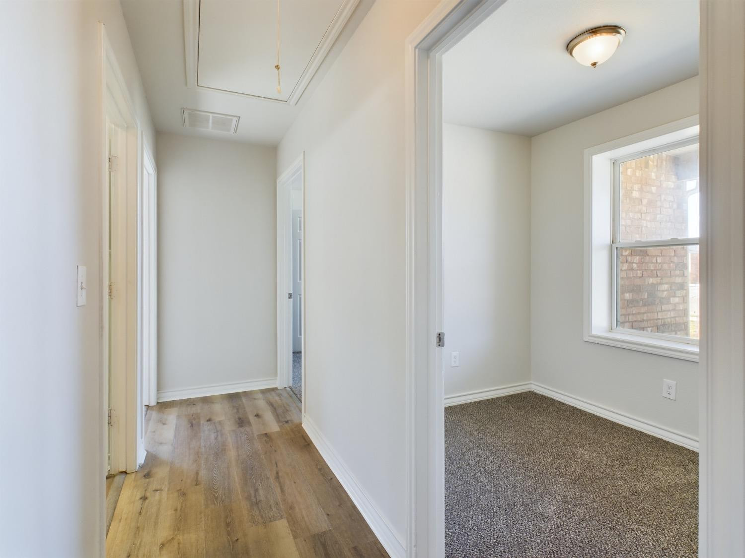6306 25th Street Lubbock, TX 79407 - Photo 6 of 37 an empty room with wooden floor and windows