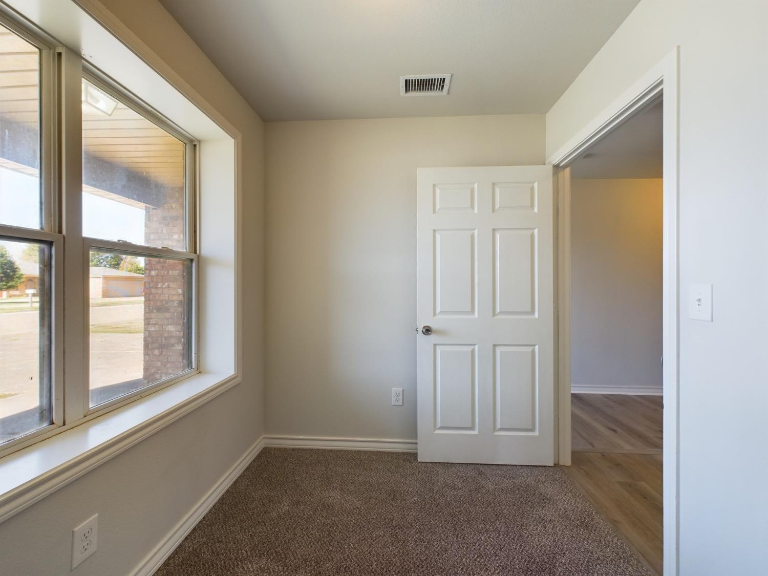 6306 25th Street Lubbock, TX 79407 - Photo 8 of 37 an empty room with windows