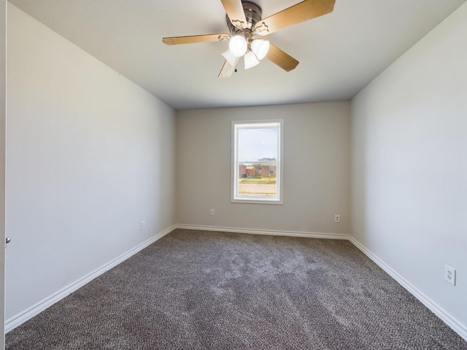6306 25th Street Lubbock, TX 79407 - Photo 10 of 37 an empty room with windows and fan