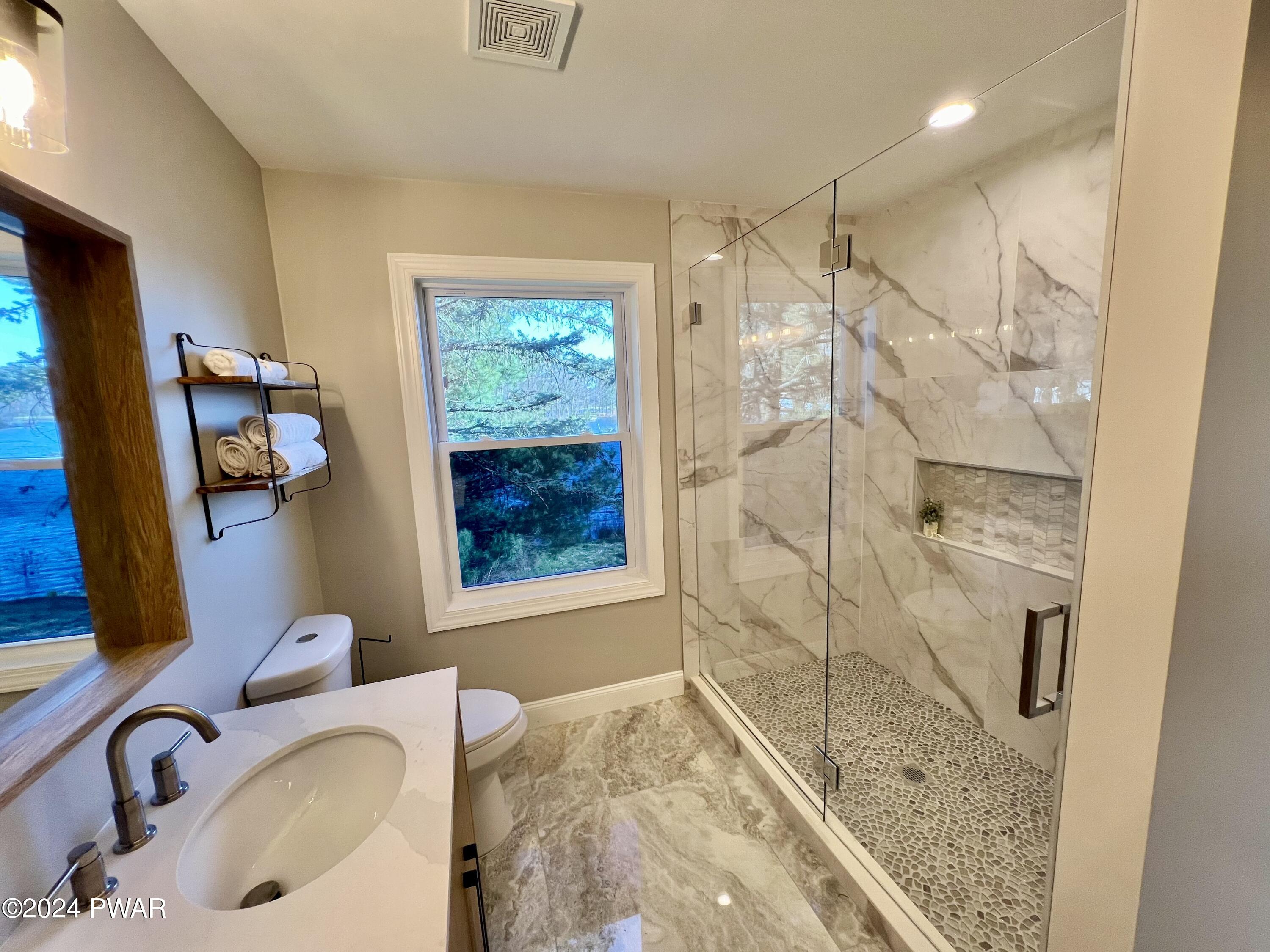194 Aspen Road Dingmans Ferry, PA 18328 - Photo 19 of 29 a bathroom with a sink toilet and shower
