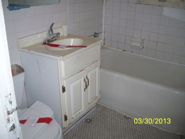 5010 North Troy Street Chicago, IL 60625 - Photo 12 of 19 a bathroom with a sink and shower