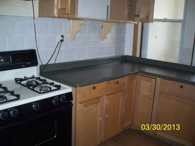 5010 North Troy Street Chicago, IL 60625 - Photo 13 of 19 a kitchen with a stove and a microwave