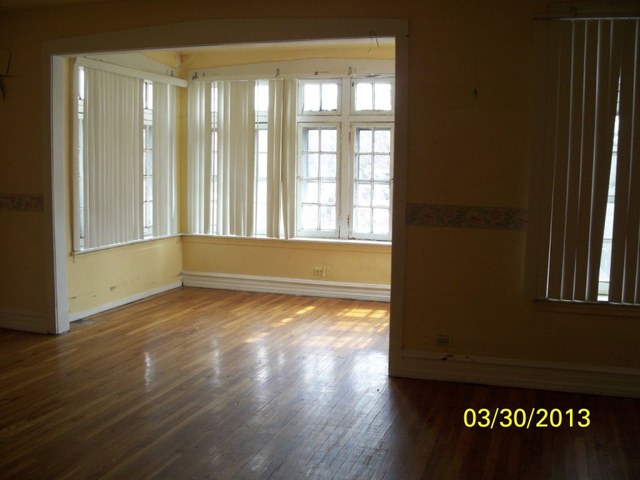 5010 North Troy Street Chicago, IL 60625 - Photo 3 of 19 a view of an empty room with wooden floor and a window