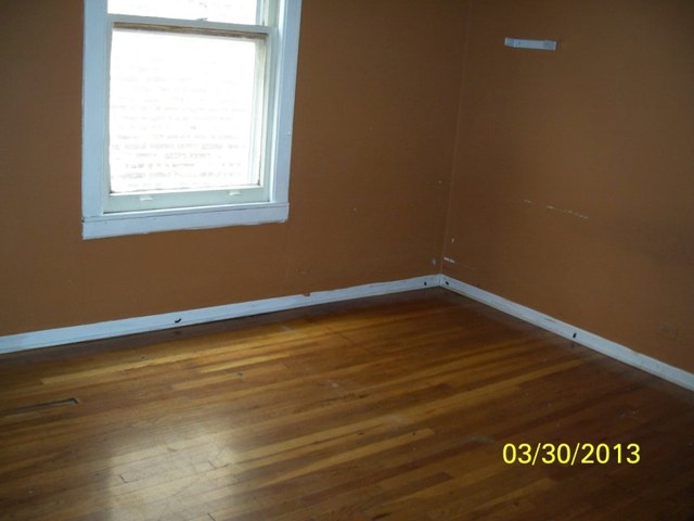 5010 North Troy Street Chicago, IL 60625 - Photo 5 of 19 a view of a room with wooden floor and windows