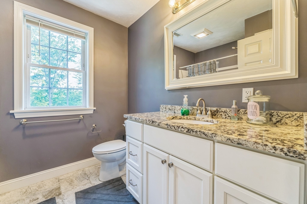 121 Adams Road East Brookfield, MA 01515 - Photo 13 of 28 a bathroom with a granite countertop sink a toilet and a window