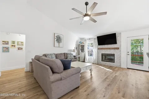 a living room with furniture a fireplace and a flat screen tv