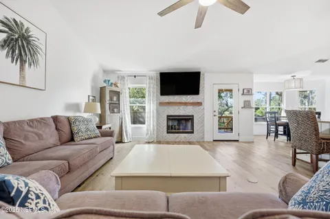 a living room with furniture fireplace and a flat screen tv