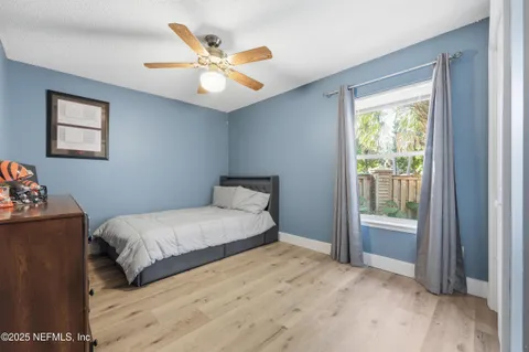 a bedroom with a large bed and a window