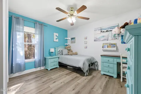 a spacious bedroom with a bed and a chandelier