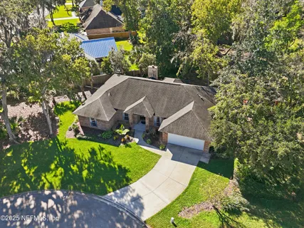 a aerial view of a house with a yard table and chairs