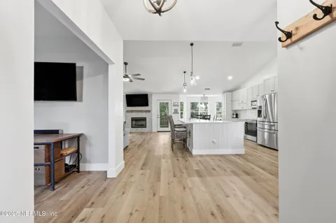 a view of kitchen with microwave a stove and furniture