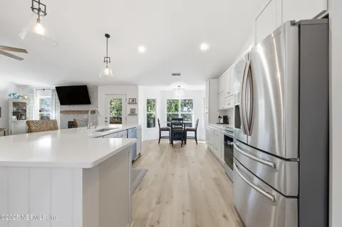 a kitchen with stainless steel appliances a refrigerator sink and microwave
