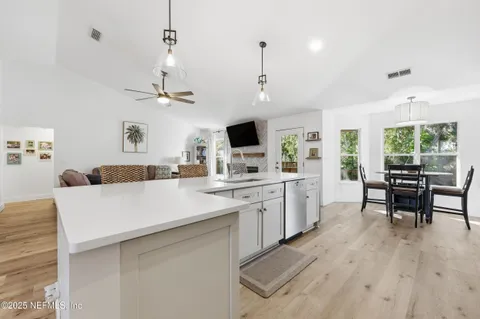 a large white kitchen with a large window