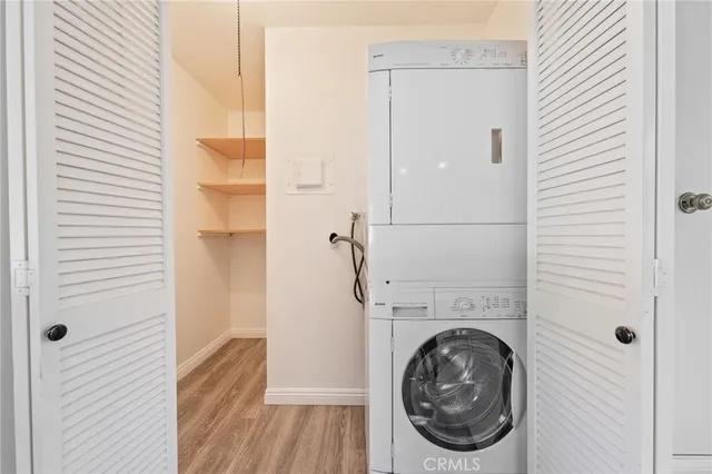 a kitchen with stainless steel appliances sink cabinets and wooden floor
