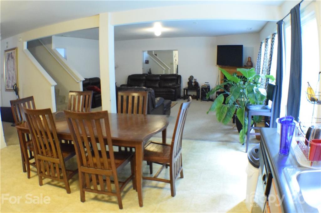 8410 Rockmoor Ridge Road Charlotte, NC 28215 - Photo 4 of 6 a view of a dining room with furniture and a flat screen tv