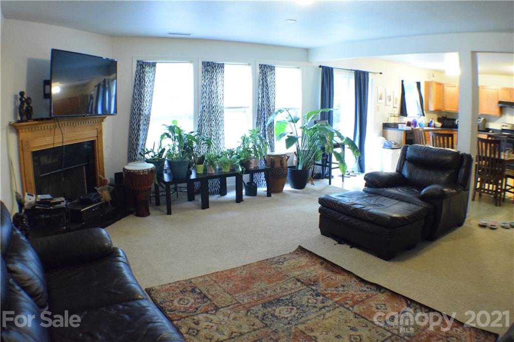 8410 Rockmoor Ridge Road Charlotte, NC 28215 - Photo 6 of 6 a living room with furniture and a fireplace