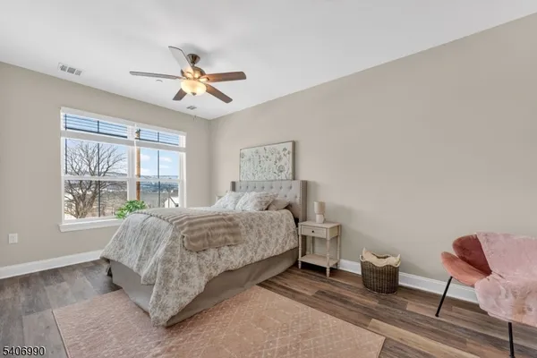a spacious bedroom with a bed and a chandelier
