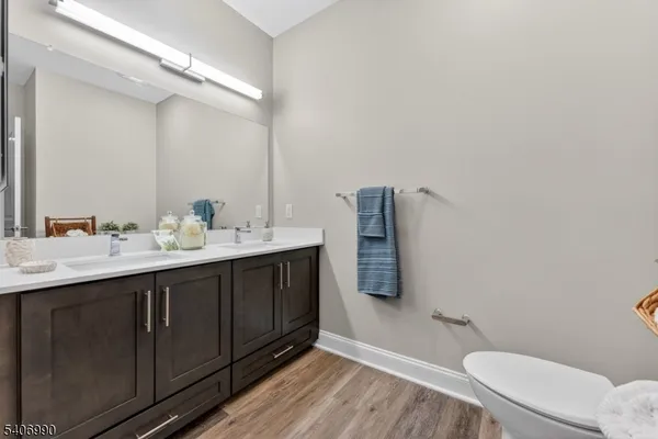 a bathroom with a sink mirror vanity and toilet