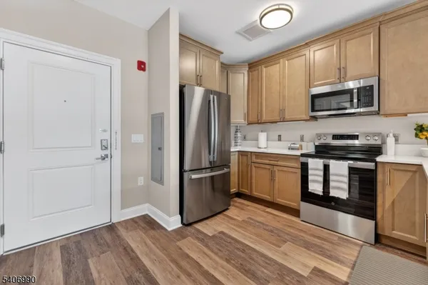 a kitchen with stainless steel appliances granite countertop a refrigerator stove and microwave