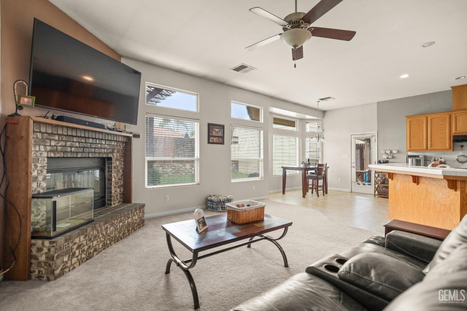 Undisclosed Address Bakersfield, CA 93306 - Photo 12 of 42 a living room with furniture a flat screen tv and a fireplace