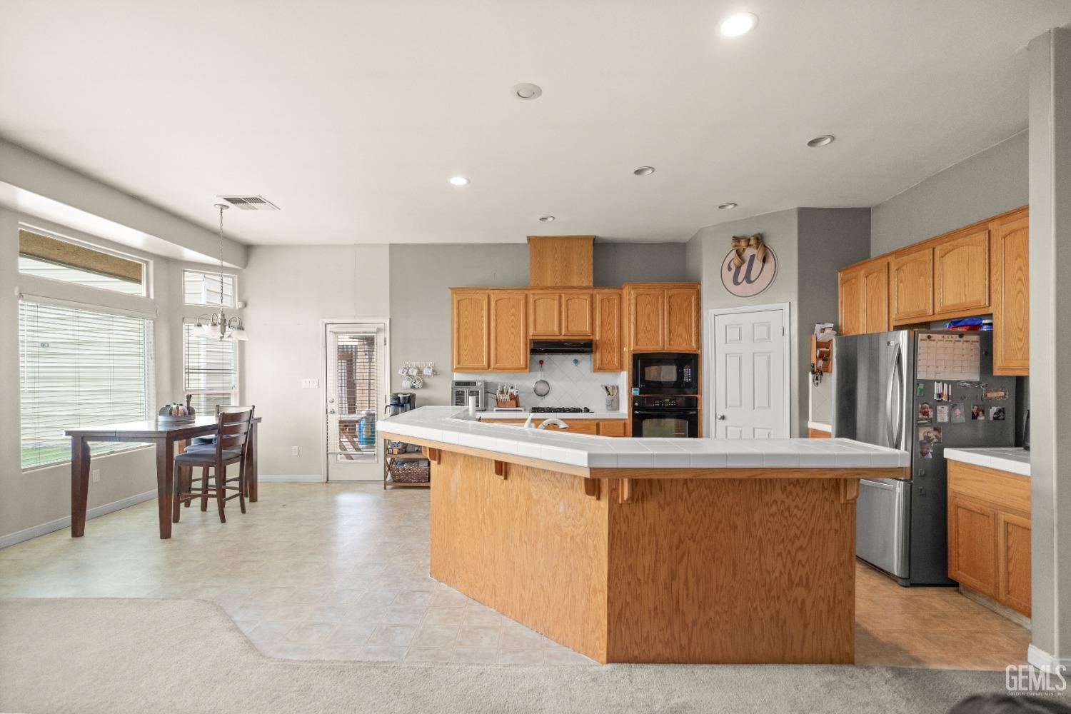 Undisclosed Address Bakersfield, CA 93306 - Photo 13 of 42 a living room with stainless steel appliances kitchen island granite countertop furniture and a kitchen view