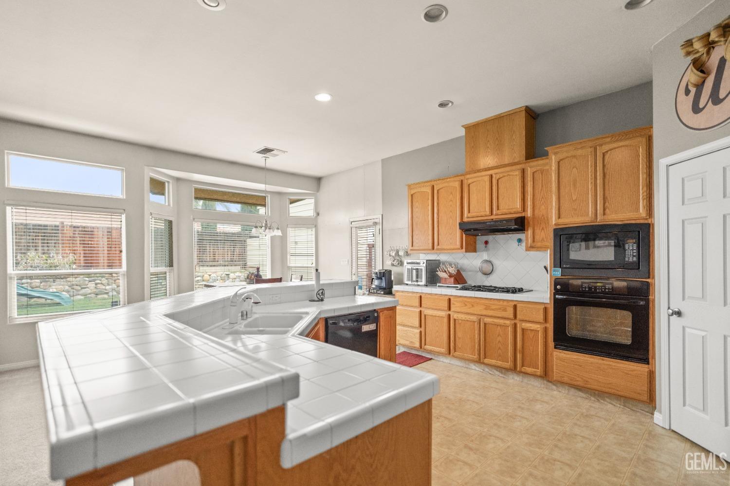 Undisclosed Address Bakersfield, CA 93306 - Photo 15 of 42 a kitchen with stainless steel appliances granite countertop a stove a sink and a refrigerator