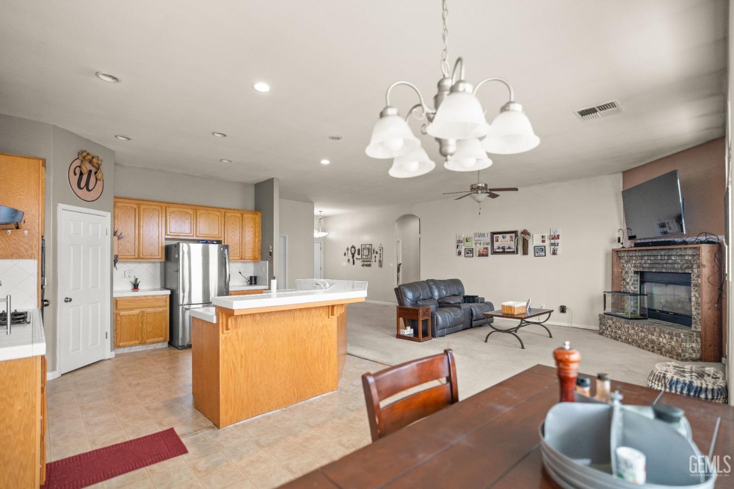Undisclosed Address Bakersfield, CA 93306 - Photo 18 of 42 a living room with stainless steel appliances kitchen island furniture and a chandelier