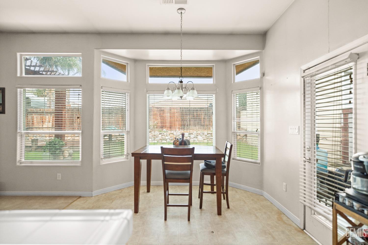 Undisclosed Address Bakersfield, CA 93306 - Photo 19 of 42 a view of a dining room with furniture large windows and wooden floor