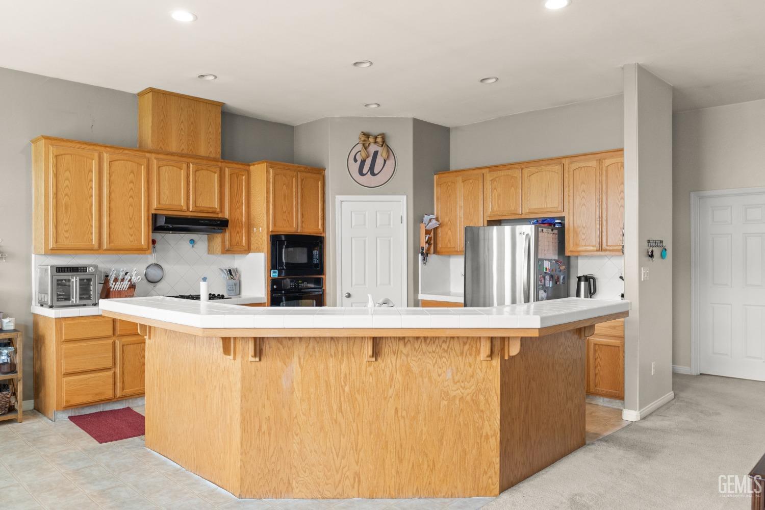 Undisclosed Address Bakersfield, CA 93306 - Photo 21 of 42 a kitchen with stainless steel appliances granite countertop a refrigerator and a stove top oven