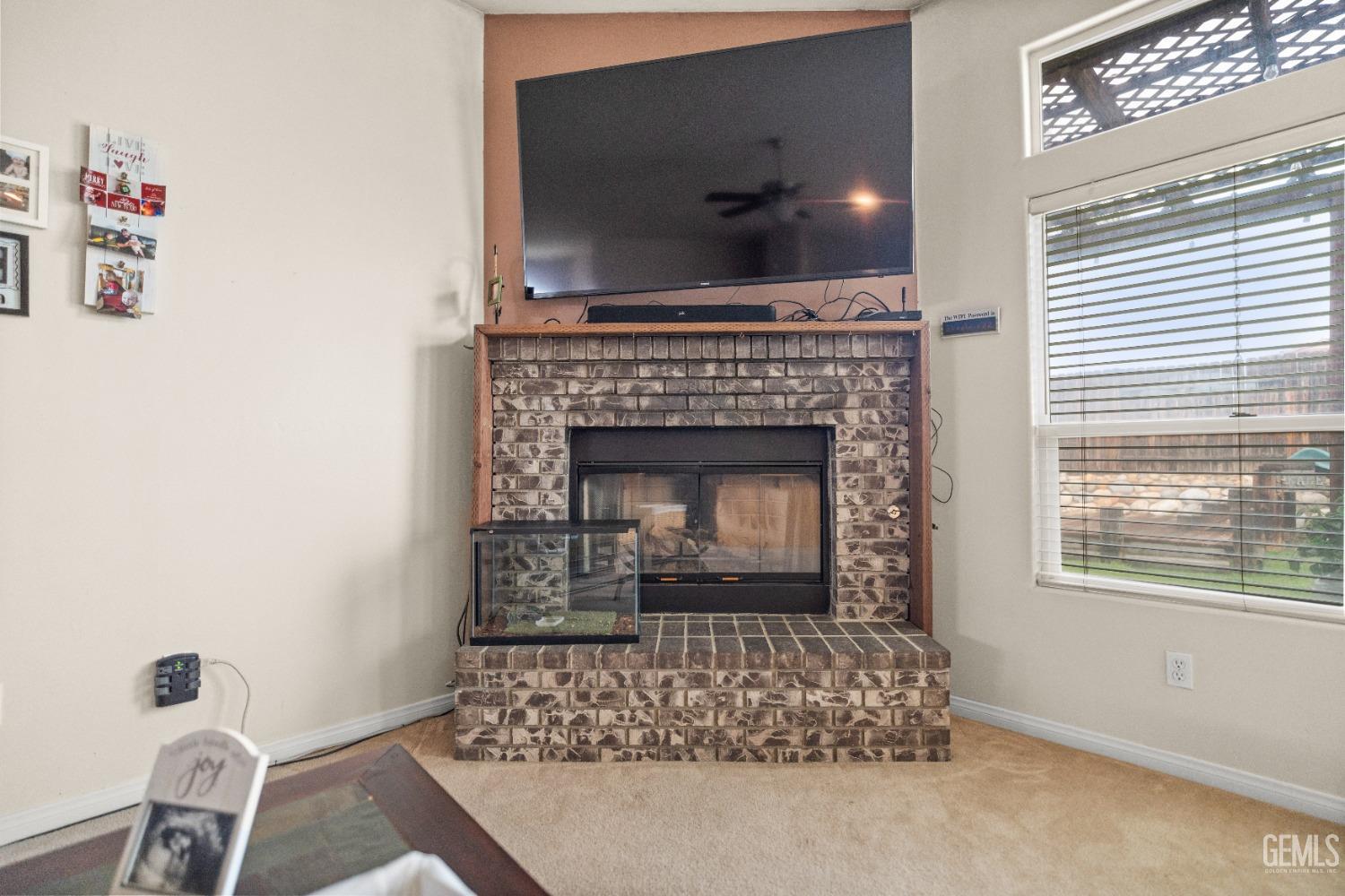Undisclosed Address Bakersfield, CA 93306 - Photo 23 of 42 a living room with a fireplace and a flat screen tv