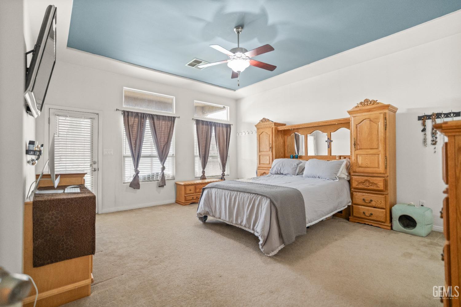 Undisclosed Address Bakersfield, CA 93306 - Photo 27 of 42 a spacious bedroom with a bed and a chandelier