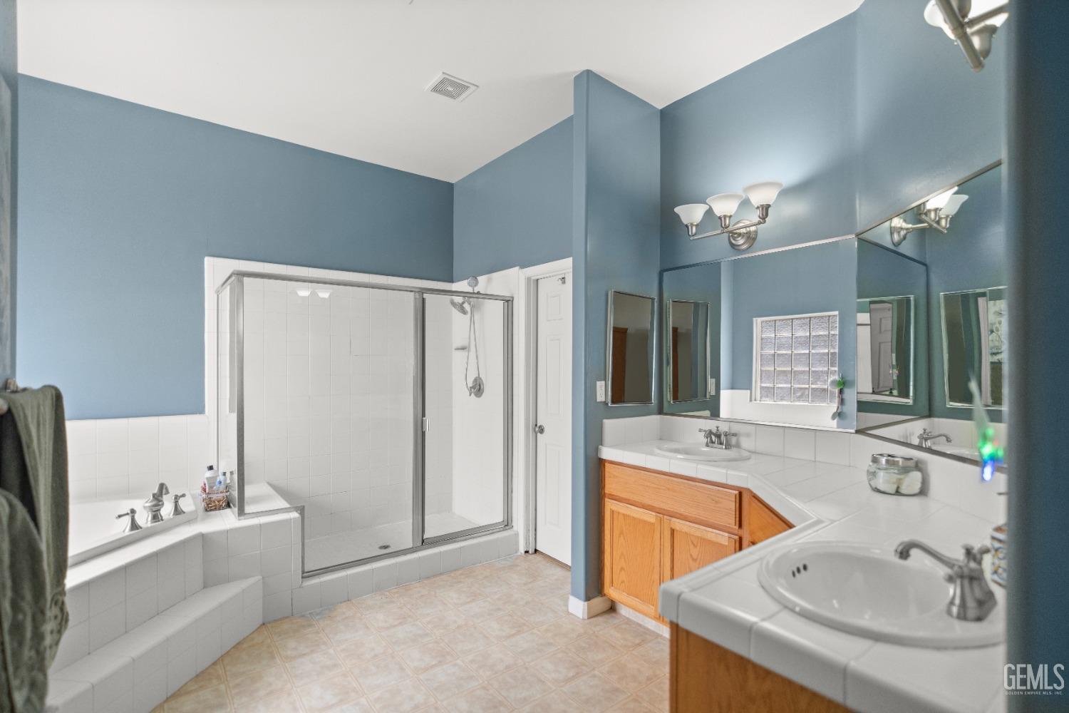 Undisclosed Address Bakersfield, CA 93306 - Photo 30 of 42 a bathroom with a tub sink and mirror