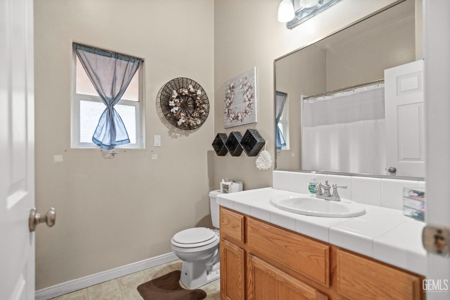 Undisclosed Address Bakersfield, CA 93306 - Photo 32 of 42 a bathroom with a toilet sink and vanity