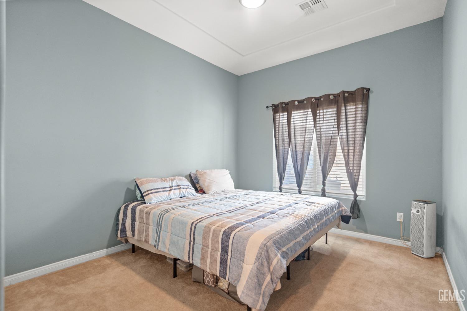 Undisclosed Address Bakersfield, CA 93306 - Photo 33 of 42 a bedroom with a bed and a window
