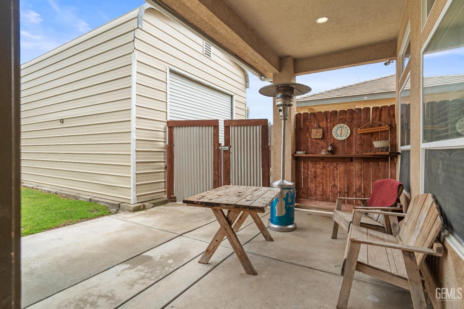 Undisclosed Address Bakersfield, CA 93306 - Photo 35 of 42 a table and chairs in front of a house