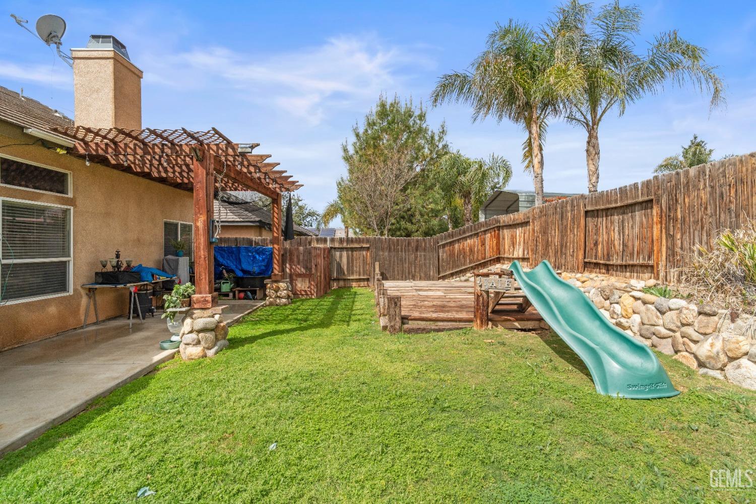Undisclosed Address Bakersfield, CA 93306 - Photo 39 of 42 a view of a swimming pool with a bench and a yard
