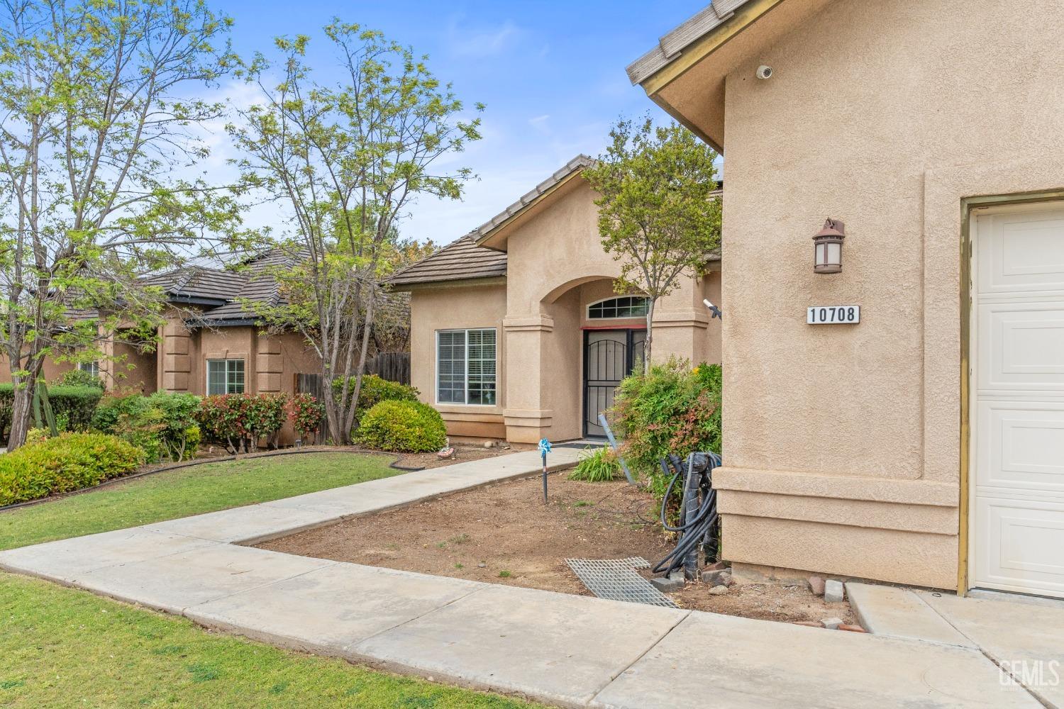 Undisclosed Address Bakersfield, CA 93306 - Photo 4 of 42 a front view of a house with garden