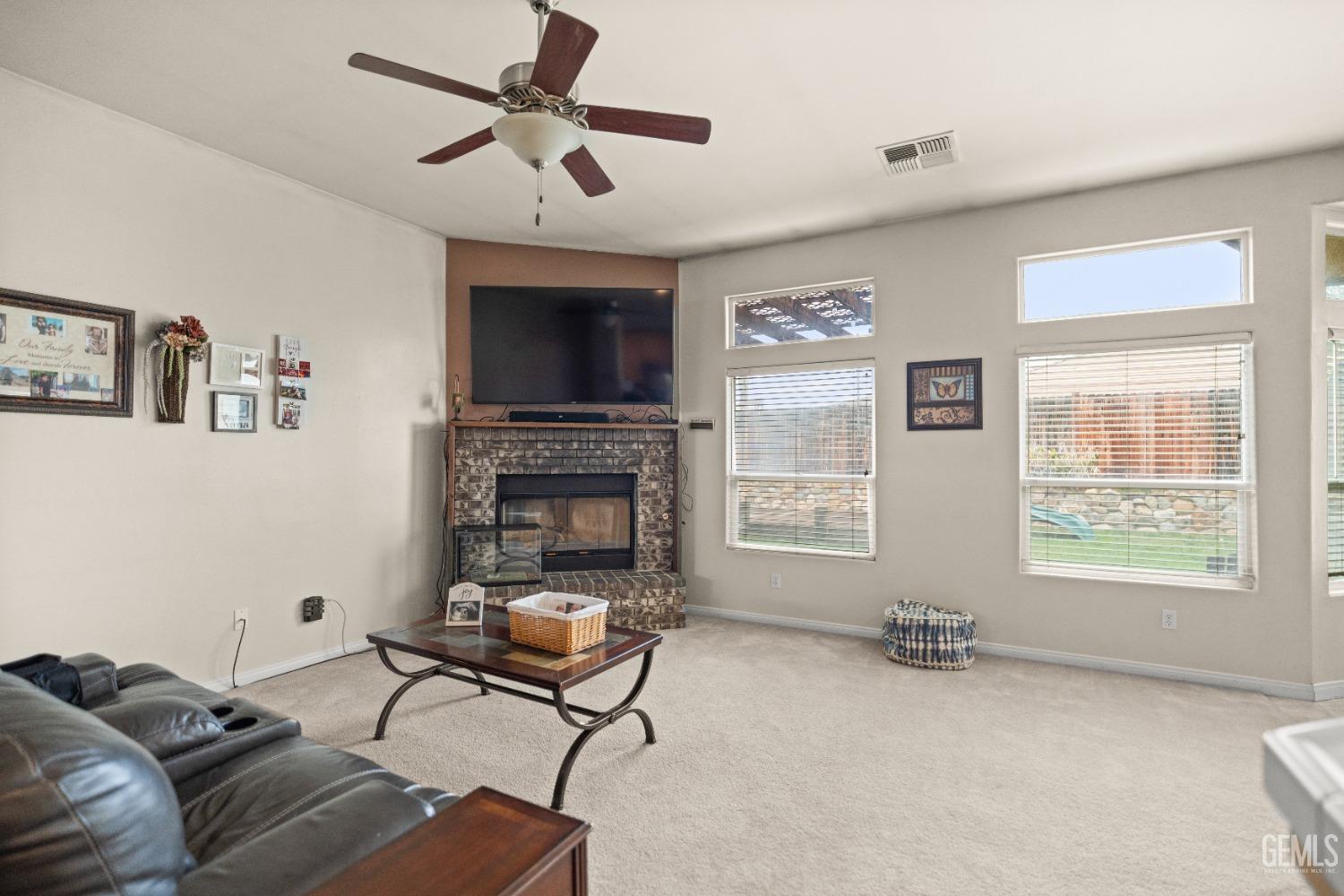 Undisclosed Address Bakersfield, CA 93306 - Photo 8 of 42 a living room with furniture and a fireplace