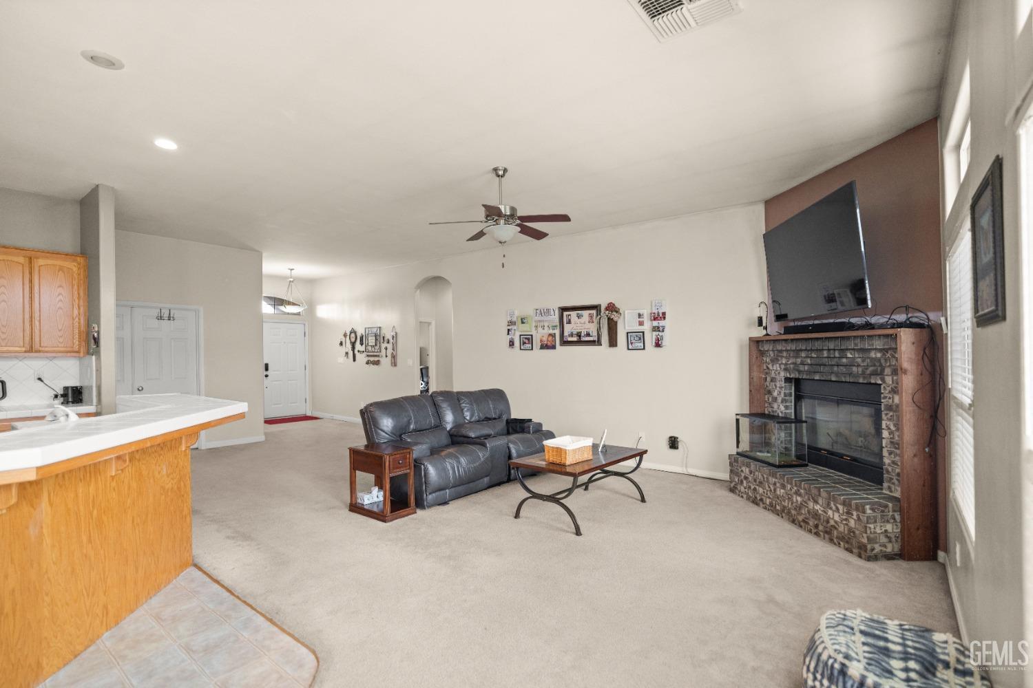 Undisclosed Address Bakersfield, CA 93306 - Photo 10 of 42 a living room with furniture and a fireplace
