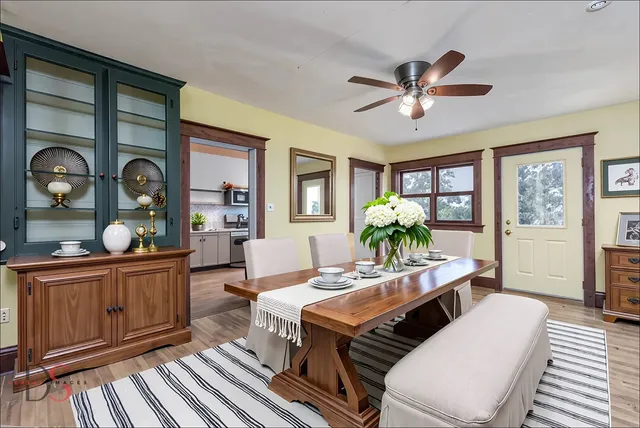 a living room with furniture a chandelier and a window