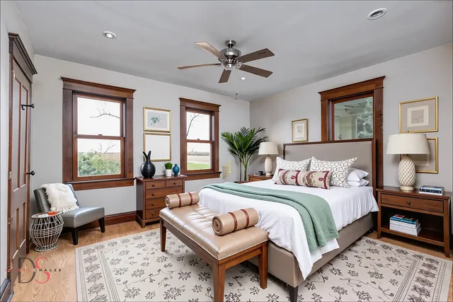 a bedroom with a bed a couch and a window