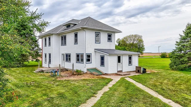 a view of a house with backyard and sitting area
