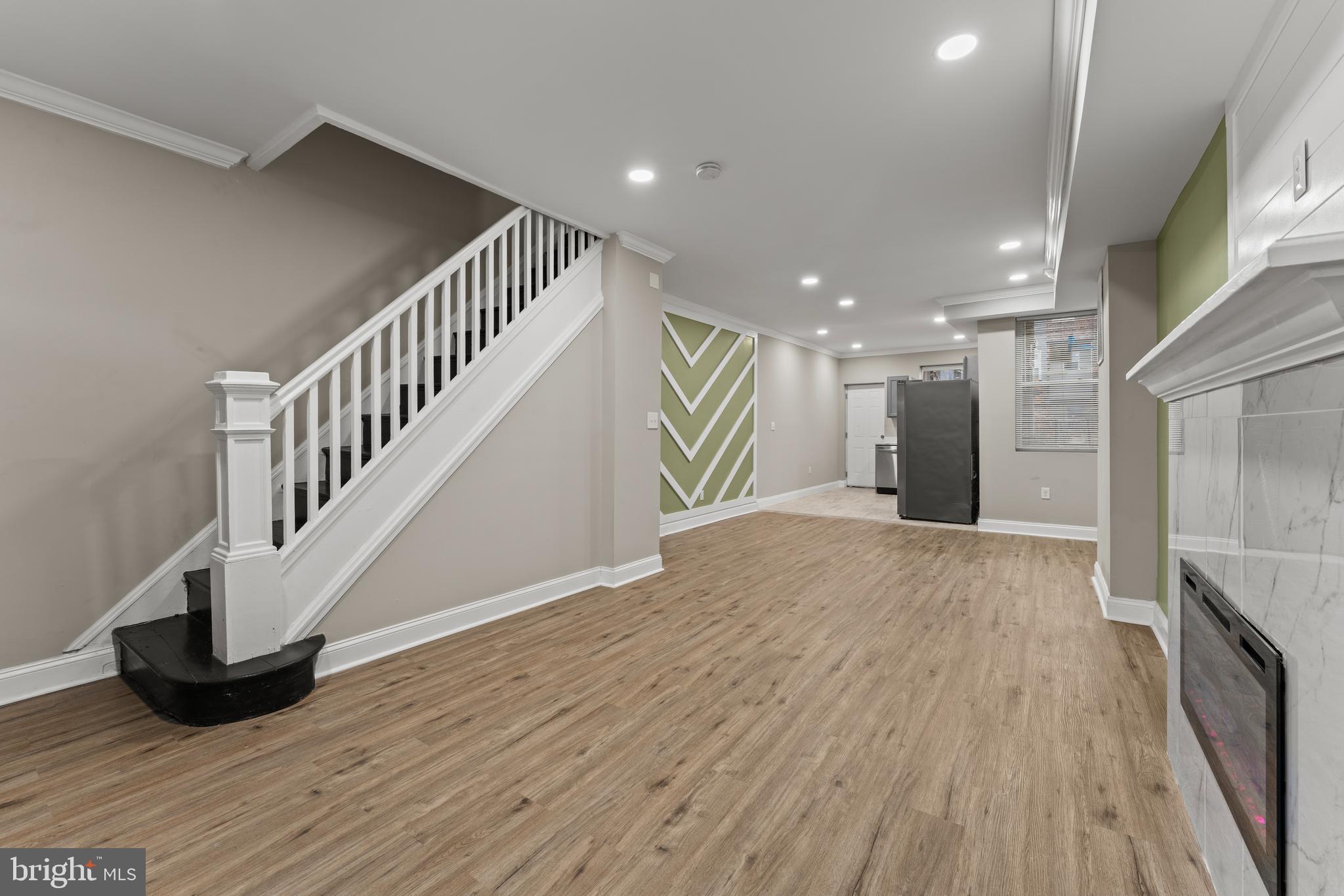 a view of entryway and hall with wooden floor