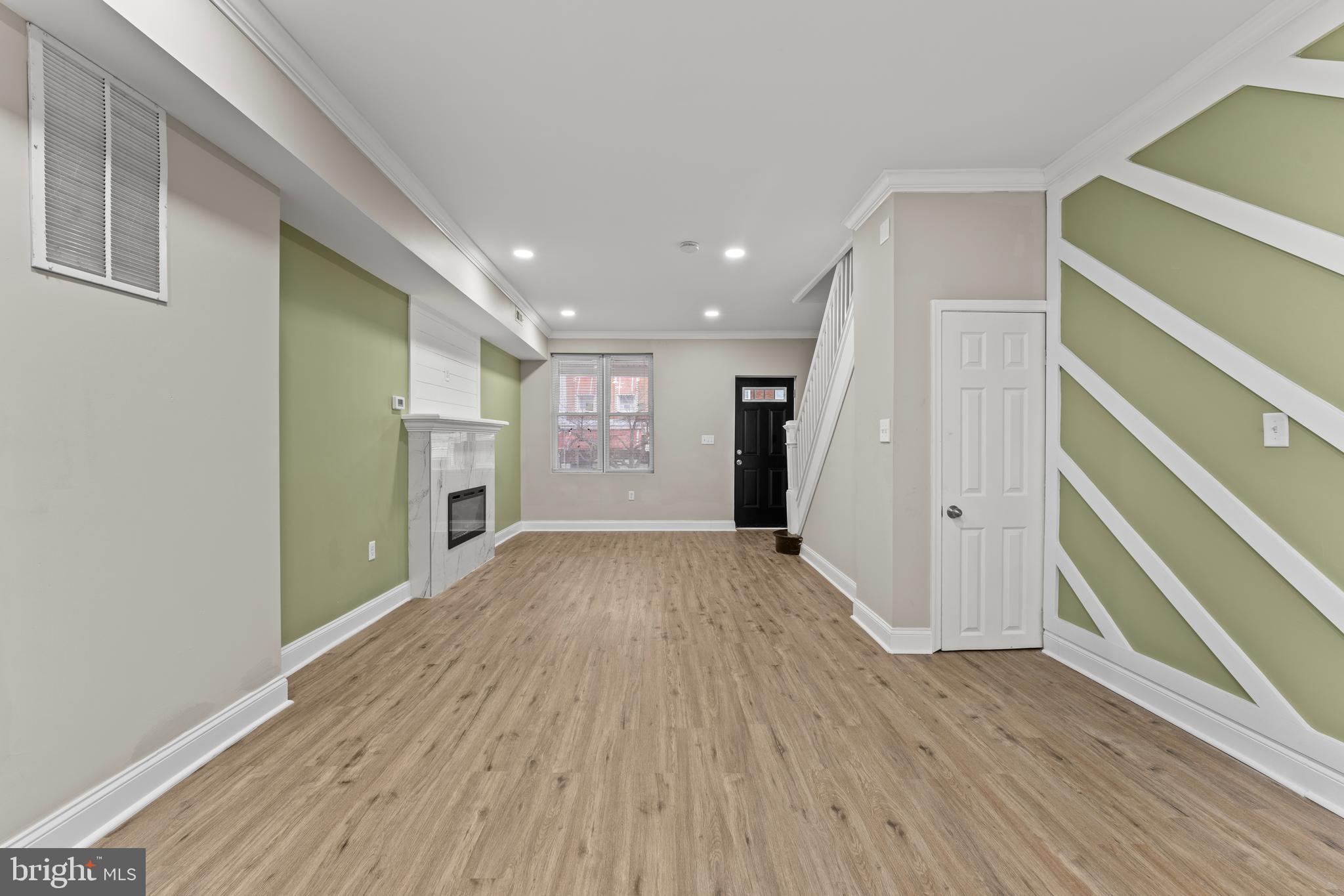 2560 Robb Street Baltimore, MD 21218 - Photo 14 of 19 a view of a hallway with wooden floor