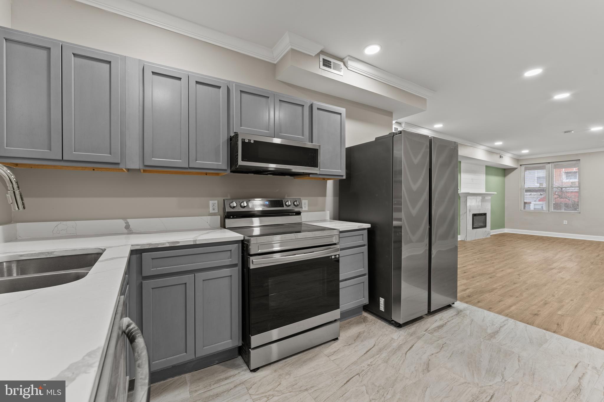 2560 Robb Street Baltimore, MD 21218 - Photo 16 of 19 a kitchen with stainless steel appliances a stove a sink and a refrigerator