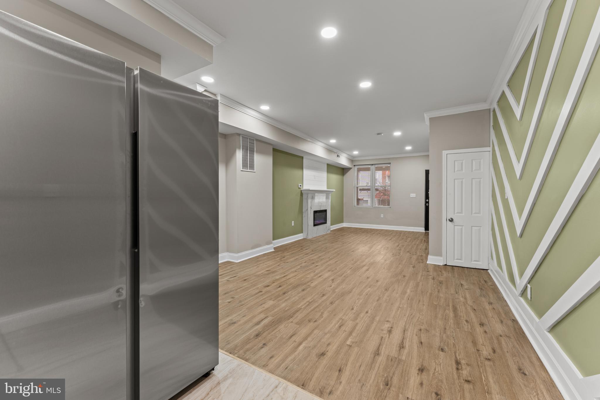 2560 Robb Street Baltimore, MD 21218 - Photo 17 of 19 a view of empty room with wooden floor