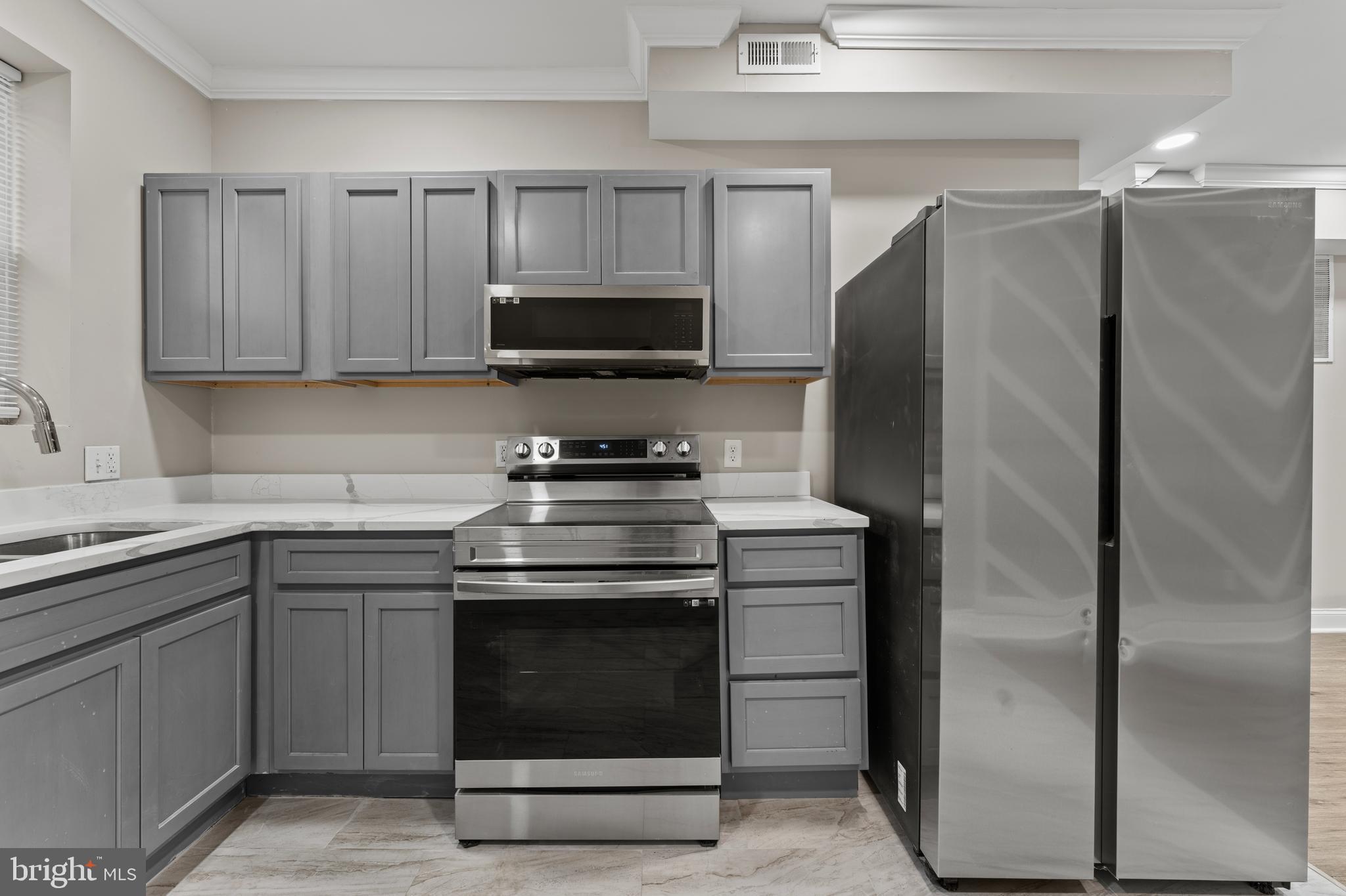 2560 Robb Street Baltimore, MD 21218 - Photo 18 of 19 a kitchen with a stove microwave and refrigerator