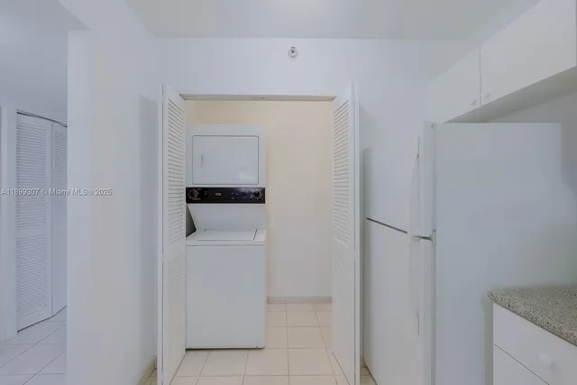 a tall building with couple of cars parked in front of it