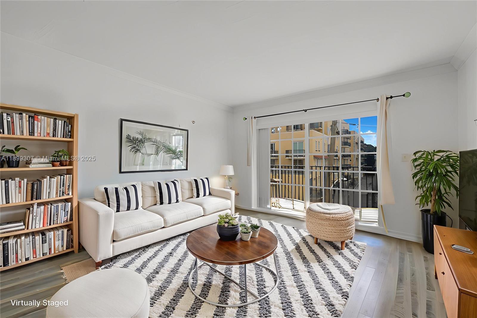 8900 Collins Avenue, Unit 301 Surfside, FL 33154 - Photo 18 of 35 a living room with furniture and a potted plant